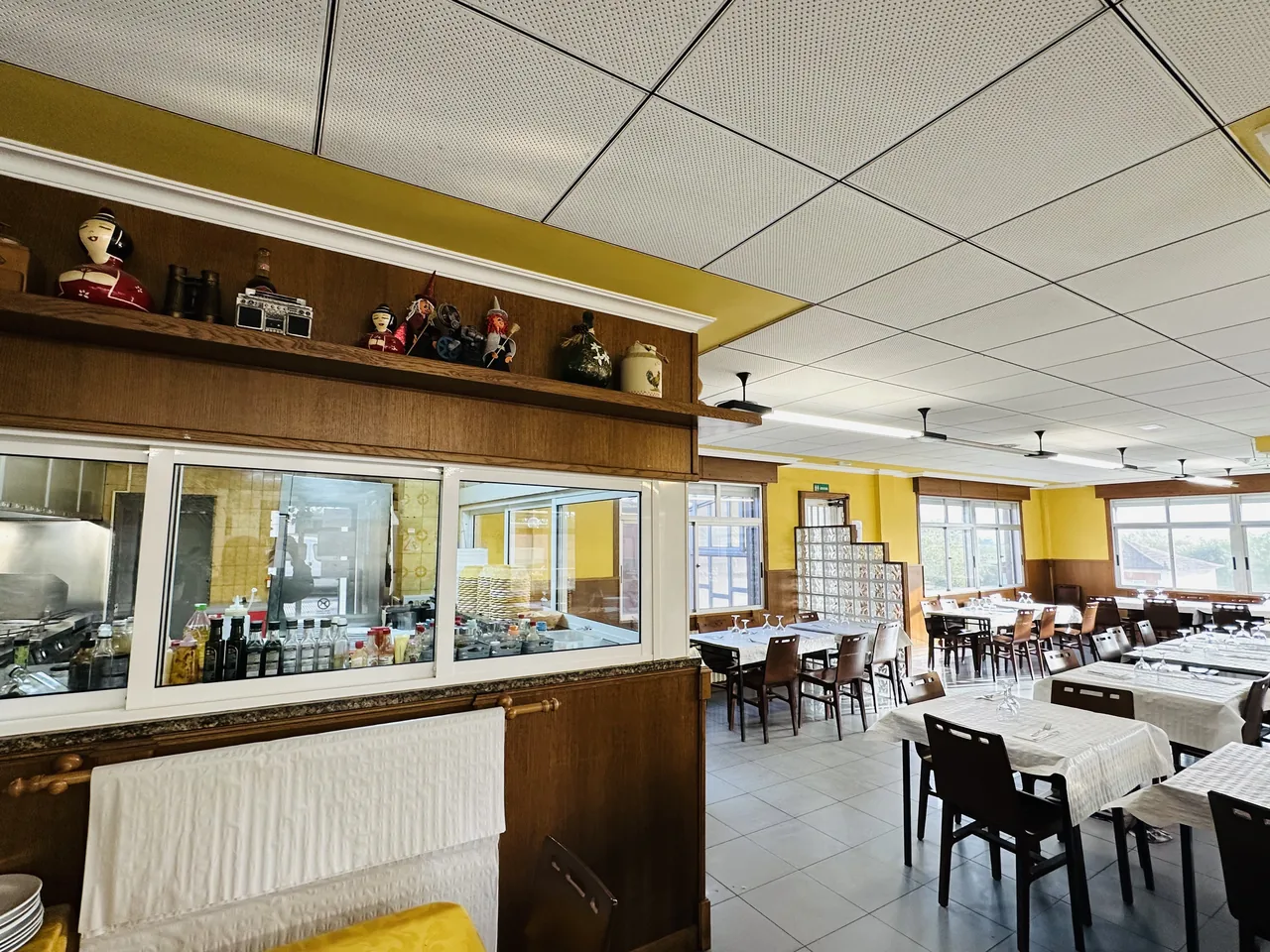 Bar de El Bosque y mesas del comedor junto a las ventanas